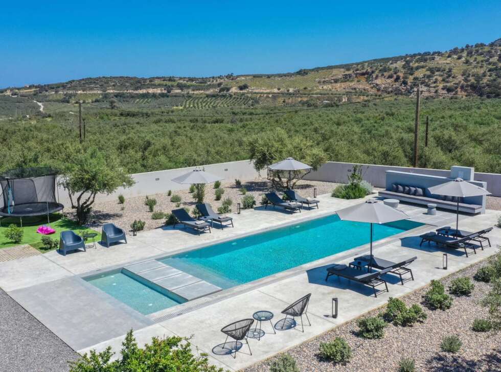 The private heated pool takes center stage among peaceful countryside surroundings.